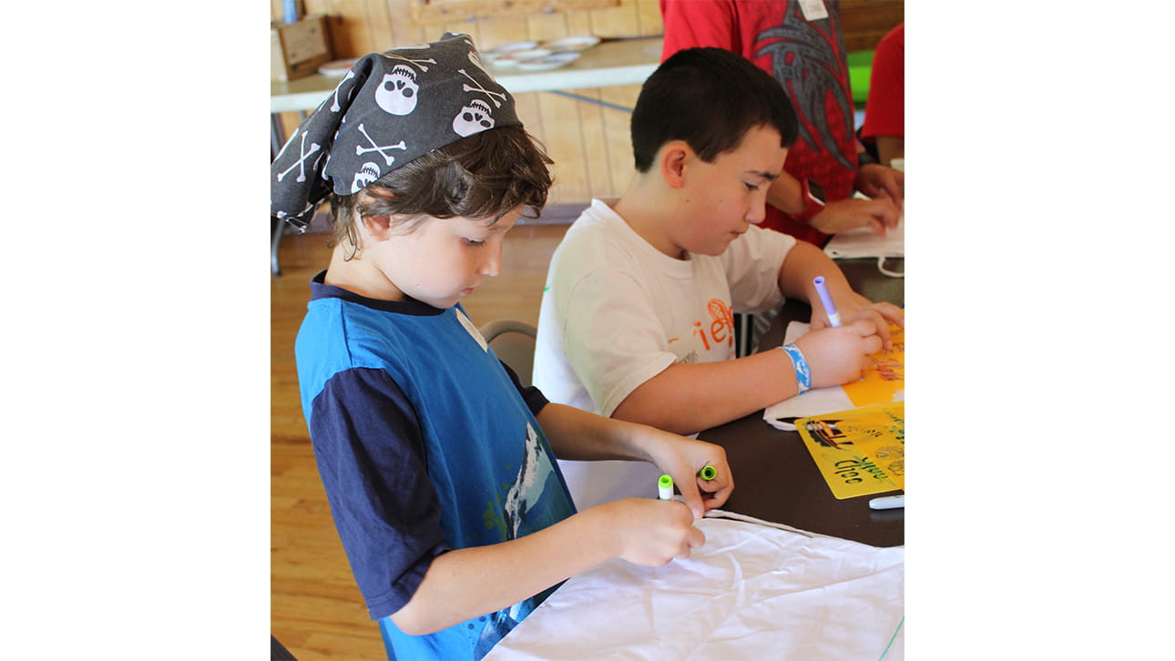 two boys doing an art activity at CompassionNet's SibsROCK! day