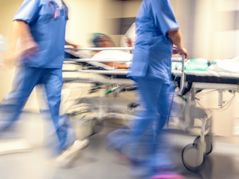 nurses rushing patient through hallways of hospital