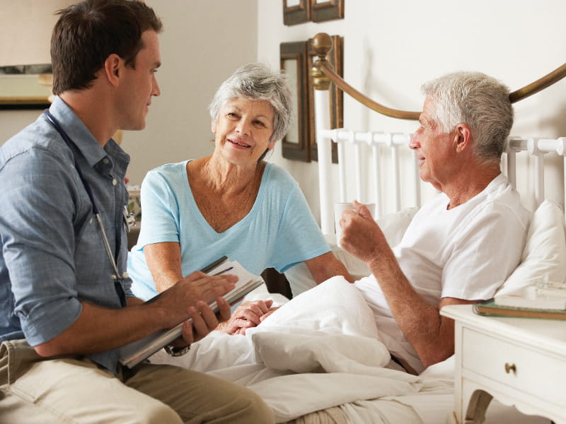 a family talking with a loved one in hospice
