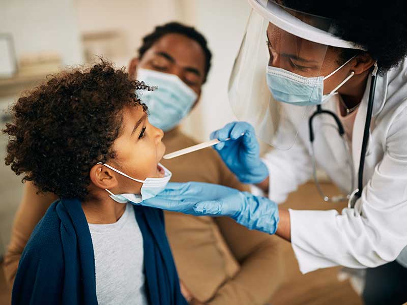 a provider examining a child's throat