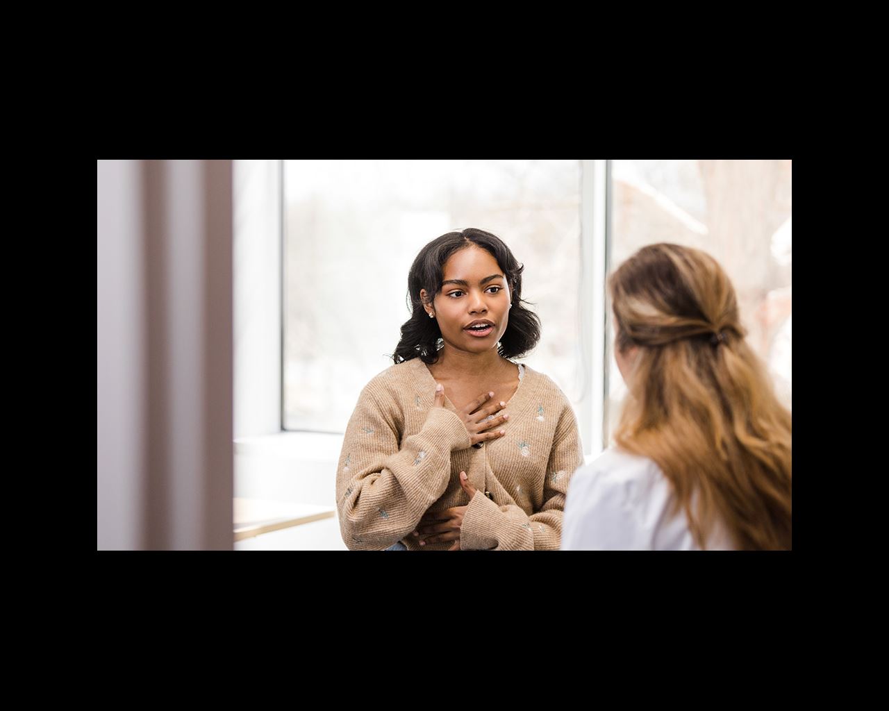 Provider listens as a female patient speaks