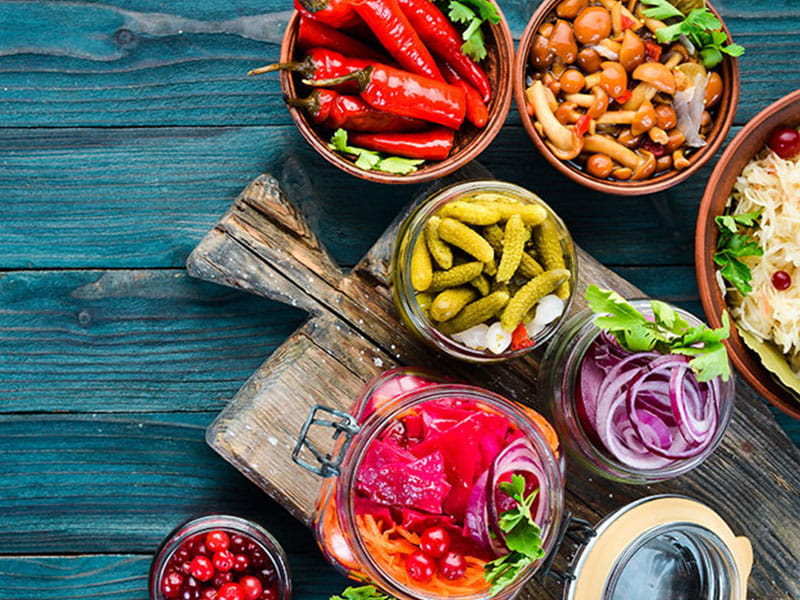 colorful array of dishes and healthy food on a wood table