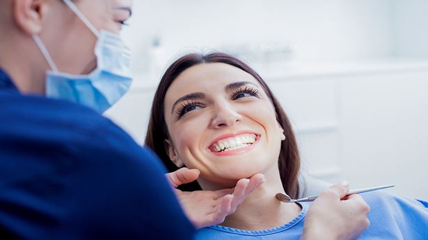 Image of a woman smiling for her dentist