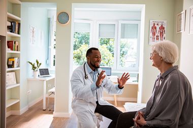 Image of a doctor talking with a senior patient about geriatric surgery