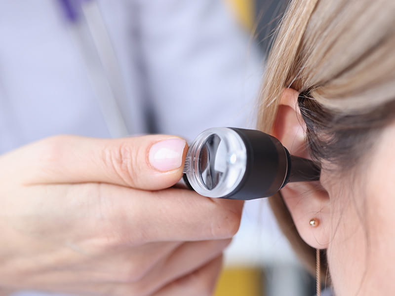 a provider looking into a patients ear