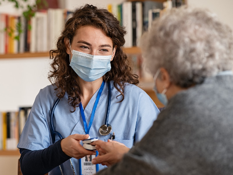 a provider conversing with a senior patient