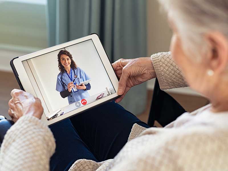 a patient using a tablet to talk to their doctor