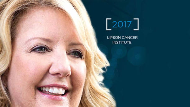 Image of woman smiling on the front cover of the Lipson Cancer Center Annual Report for 2017.