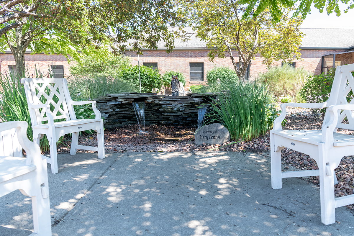 An outdoor “garden-like” courtyard boasts a central fountain and seating for residents and families to share.